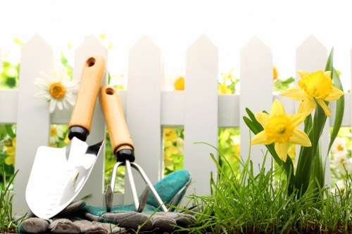 Professional gardeners working safely while maintaining a garden